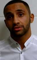 Kid Galahad in a white shirt looking at the camera