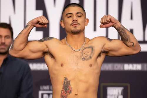 Joseph JoJo Diaz flexing his muscles at a weigh-in
