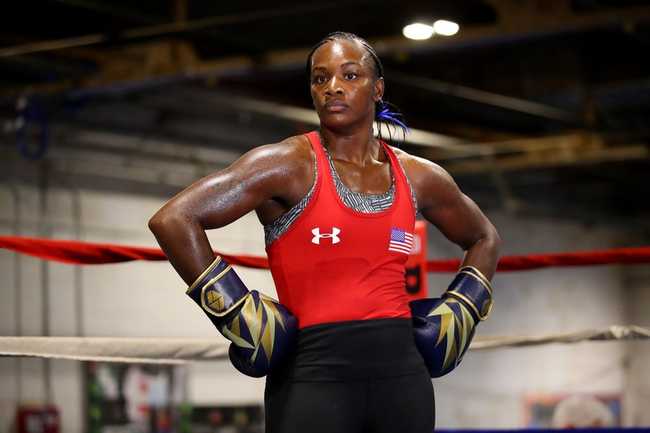 Claressa Shields standing in a boxing ring in a gym