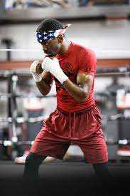 Jamel Herring wearing read doing some shadow boxing in a ring