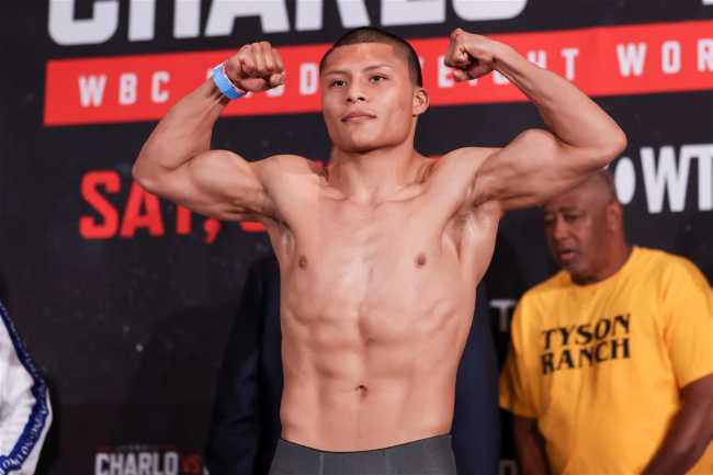 Isaac Cruz doing a muscle pose at a weigh in
