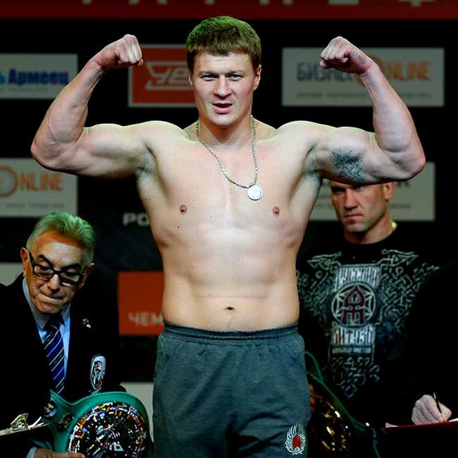 Alexander Povetkin in his underwear at a weigh-in, doing a muscle pose